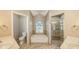 Elegant bathroom with double sinks, soaking tub, and shower at 42 Marker Rd, Rotonda West, FL 33947