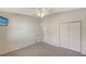 Bright bedroom with ceiling fan, wall-mounted TV, and double-door closet at 42 Marker Rd, Rotonda West, FL 33947