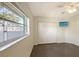 Well-lit bedroom with large window, closet and dark tile floor at 42 Marker Rd, Rotonda West, FL 33947