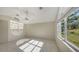 Bedroom with tile floor and large window at 42 Marker Rd, Rotonda West, FL 33947