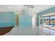 Open living room with tile floors and access to the pool area at 42 Marker Rd, Rotonda West, FL 33947