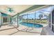 Oval pool with a screened enclosure and backyard view at 42 Marker Rd, Rotonda West, FL 33947