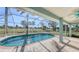 Relaxing screened pool area overlooking lush landscape at 42 Marker Rd, Rotonda West, FL 33947