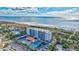 Aerial perspective of a beachfront condominium with on-site tennis courts and a clear ocean view at 420 Beach Rd # 203, Sarasota, FL 34242