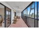 Screened-in balcony with seating and ocean views at 420 Beach Rd # 203, Sarasota, FL 34242
