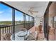 Relaxing screened balcony with seating area and beautiful ocean views at 420 Beach Rd # 203, Sarasota, FL 34242
