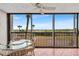 Screened balcony with table and chairs, offering stunning ocean views at 420 Beach Rd # 203, Sarasota, FL 34242