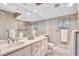 Elegant bathroom with double vanity, glass shower, and decorative tile accents at 420 Beach Rd # 203, Sarasota, FL 34242
