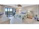 Bright bedroom with beach-inspired decor and access to a private balcony at 420 Beach Rd # 203, Sarasota, FL 34242