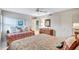 Bedroom with two beds, wicker furniture, and closet at 420 Beach Rd # 203, Sarasota, FL 34242