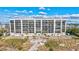 Luxury beachfront condo with large windows, balconies, and a private boardwalk to the beach and lush landscaping at 420 Beach Rd # 203, Sarasota, FL 34242