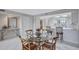 Dining area with glass-top table, wooden chairs, and view of the kitchen at 420 Beach Rd # 203, Sarasota, FL 34242