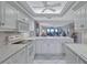 White kitchen with ocean view and breakfast bar at 420 Beach Rd # 203, Sarasota, FL 34242