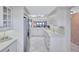 White galley kitchen with stainless steel appliances at 420 Beach Rd # 203, Sarasota, FL 34242