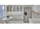 White kitchen with stainless steel appliances and breakfast nook at 420 Beach Rd # 203, Sarasota, FL 34242