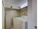 Compact laundry room with washer, dryer, and ironing board at 420 Beach Rd # 203, Sarasota, FL 34242