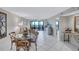 Open-concept living and dining area with access to a balcony and ocean views at 420 Beach Rd # 203, Sarasota, FL 34242