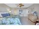 Large main bedroom with ceiling fan, ensuite bathroom, and ample closet space at 420 Beach Rd # 203, Sarasota, FL 34242