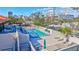 Community pool area with lounge chairs, tables, and surrounding landscaping at 420 Beach Rd # 203, Sarasota, FL 34242
