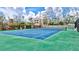 View of community tennis court with nearby houses at 420 Beach Rd # 203, Sarasota, FL 34242