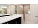 Modern bathroom with double vanity, large shower, and bright lighting at 4326 Tamarind Pl, Bradenton, FL 34203