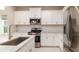 Modern kitchen with white cabinets, stainless steel appliances and granite countertops at 4326 Tamarind Pl, Bradenton, FL 34203