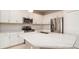 Modern kitchen with white cabinets, stainless steel appliances and a large island at 4326 Tamarind Pl, Bradenton, FL 34203