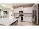 Modern kitchen with white cabinets, stainless steel appliances and granite countertops at 4326 Tamarind Pl, Bradenton, FL 34203