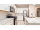 Modern kitchen with white cabinets and stainless steel appliances at 4326 Tamarind Pl, Bradenton, FL 34203