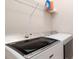 Laundry room with a washer and dryer and overhead shelving at 4326 Tamarind Pl, Bradenton, FL 34203