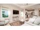 Bright living room with open concept kitchen, modern furniture, and large TV at 4326 Tamarind Pl, Bradenton, FL 34203