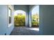 Covered patio with arched entryway, brick pavers, and lush greenery at 4326 Tamarind Pl, Bradenton, FL 34203
