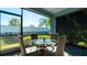 Enjoyable screened porch with a glass-top table and wicker chairs at 4326 Tamarind Pl, Bradenton, FL 34203