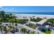 Overhead view of a beach with palm trees, volleyball nets, and a modern building at 4626 Gleason Ave, Sarasota, FL 34242