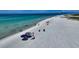 Picturesque beach view with clear blue water, white sand, and people enjoying the scenery at 4626 Gleason Ave, Sarasota, FL 34242