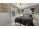 Cozy bedroom featuring neutral walls, a dark comforter, and ample natural light, creating a comfortable and inviting space at 4626 Gleason Ave, Sarasota, FL 34242