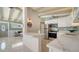 Open-concept kitchen featuring white cabinets, quartz countertops, and stainless steel appliances at 4626 Gleason Ave, Sarasota, FL 34242