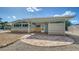 Charming outdoor space with brick patio, partial privacy screen, and ceiling fan at 4626 Gleason Ave, Sarasota, FL 34242