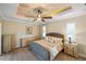 Bright bedroom with king-size bed, dresser, and ceiling fan at 490 Capri Isles Ct, Punta Gorda, FL 33950