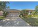 House exterior with a two-car garage and manicured lawn at 4978 Cedar Oak Way, Sarasota, FL 34233