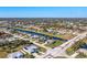 Aerial view of a residential area, showcasing houses and a canal at 527 Rotonda Cir, Rotonda West, FL 33947