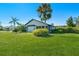 Spacious backyard with lush green grass and a partially visible home at 527 Rotonda Cir, Rotonda West, FL 33947