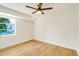 Well-lit bedroom featuring light wood floors and a window at 527 Rotonda Cir, Rotonda West, FL 33947