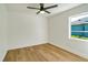 Simple bedroom with light wood floors and a window with natural light at 527 Rotonda Cir, Rotonda West, FL 33947