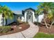 Attractive single-story home with a landscaped front yard and walkway at 527 Rotonda Cir, Rotonda West, FL 33947