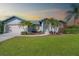 One-story home with landscaped lawn and palm trees at 527 Rotonda Cir, Rotonda West, FL 33947
