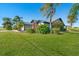 House exterior showcasing a side view with landscaping and grass at 527 Rotonda Cir, Rotonda West, FL 33947