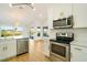 Modern kitchen with white cabinets and stainless steel appliances at 527 Rotonda Cir, Rotonda West, FL 33947