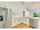Updated kitchen featuring white shaker cabinets and gold hardware at 527 Rotonda Cir, Rotonda West, FL 33947