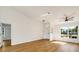 Bright living room with large windows, wood floors, and a view of the front yard at 527 Rotonda Cir, Rotonda West, FL 33947